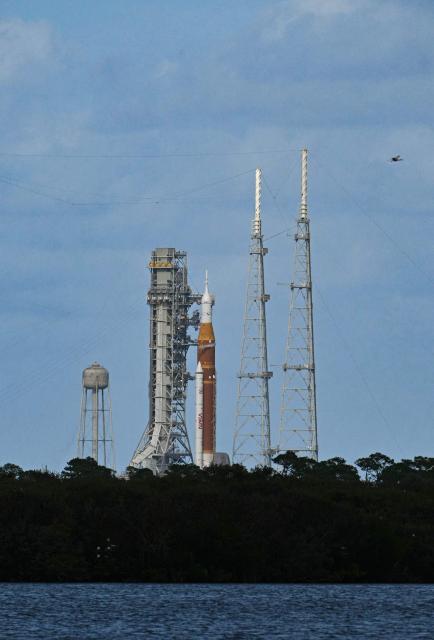 NASA's Artemis II Space Launch System rocket and Orion spacecraft rest on Launch Pad 39B at Kennedy Space Center in Cape Canaveral, Florida, on April 1, 2026, ahead of the crewed lunar mission. Three men and one woman are set to embark on the first crewed journey to the Moon since 1972, a landmark odyssey that aims to launch the US into a new era of space exploration. The NASA mission dubbed Artemis 2 has been years in the making after facing repeated setbacks, but is finally scheduled to take off from Florida as early as April 1 at 6:24 pm (2224 GMT). (Photo by Jim WATSON / AFP)