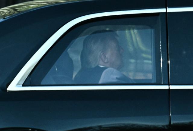US President Donald Trump rides in his motorcade as he departs the White House for the US Supreme Court in Washington, DC, on April 1, 2026. Trump attended in person as the US Supreme Court heard a landmark case weighing the constitutionality of his contentious bid to end birthright citizenship, an extraordinary and possibly unprecedented move for the nation's highest office. (Photo by Brendan SMIALOWSKI / AFP)