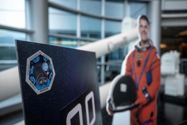A cardboard cutout of Canadian astronaut Jeremy Hansen at the Canadian Space Agency (CSA) before a viewing party of the Artemis II launch, in Longueuil, near Montreal, Quebec, on April 1, 2026. Three men and one woman are set to embark on the first crewed journey to the Moon since 1972, a landmark odyssey that aims to launch the US into a new era of space exploration. The NASA mission dubbed Artemis II has been years in the making after facing repeated setbacks, but is finally scheduled to take off from Florida as early as April 1 at 6:24 pm (2224 GMT). (Photo by ANDREJ IVANOV / AFP)