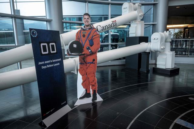 A cardboard cutout of Canadian astronaut Jeremy Hansen at the Canadian Space Agency (CSA) before a viewing party of the Artemis II launch, in Longueuil, near Montreal, Quebec, on April 1, 2026. Three men and one woman are set to embark on the first crewed journey to the Moon since 1972, a landmark odyssey that aims to launch the US into a new era of space exploration. The NASA mission dubbed Artemis II has been years in the making after facing repeated setbacks, but is finally scheduled to take off from Florida as early as April 1 at 6:24 pm (2224 GMT). (Photo by ANDREJ IVANOV / AFP)