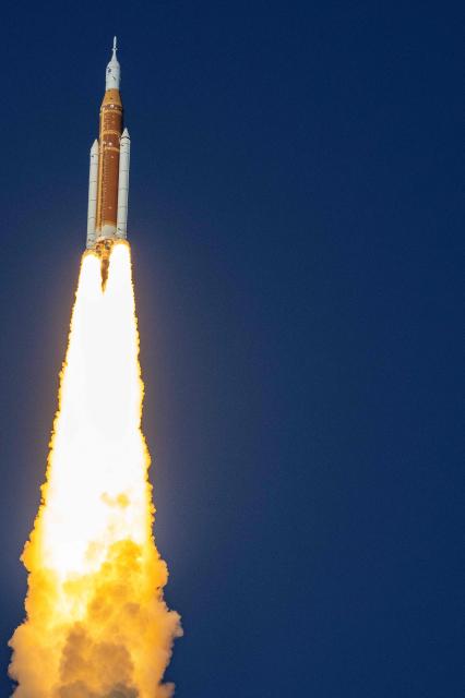 The Artemis II crewed lunar mission launches at Kennedy Space Center in Cape Canaveral, Florida, on April 1, 2026. Four astronauts blasted off aboard a massive NASA rocket April 1 on a long-anticipated journey around the Moon, the first crewed lunar flyby in more than 50 years. With an intense roar that reverberated far beyond the launchpad, the enormous orange-and-white rocket carried three Americans and one Canadian away from Florida's Kennedy Space Center at approximately 6:35 pm local time, according to an AFP journalist onsite. "We're going to the Moon!" yelled a spectator. (Photo by Jim WATSON / AFP)