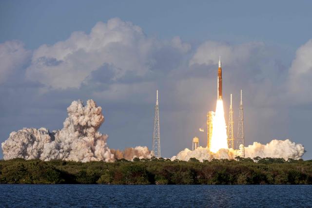 The Artemis II crewed lunar mission lifts off from Pad 39B at Kennedy Space Center in Cape Canaveral, Florida, on April 1, 2026. Four astronauts blasted off aboard a massive NASA rocket April 1 on a long-anticipated journey around the Moon, the first crewed lunar flyby in more than 50 years. With an intense roar that reverberated far beyond the launchpad, the enormous orange-and-white rocket carried three Americans and one Canadian away from Florida's Kennedy Space Center at approximately 6:35 pm local time, according to an AFP journalist onsite. "We're going to the Moon!" yelled a spectator. (Photo by Jim WATSON / AFP)