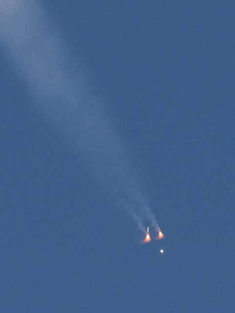 The two solid rocket boosters separate from NASA's Artemis II Space Launch System (SLS) rocket and Orion spacecraft are seen as it soars into orbit after lifting off from Launch Pad 39B at the Kennedy Space Center in Cape Canaveral, Florida on April 1, 2026. Four astronauts blasted off aboard a massive NASA rocket April 1 on a long-anticipated journey around the Moon, the first crewed lunar flyby in more than 50 years. With an intense roar that reverberated far beyond the launchpad, the enormous orange-and-white rocket carried three Americans and one Canadian away from Florida's Kennedy Space Center at approximately 6:35 pm local time, according to an AFP journalist onsite. "We're going to the Moon!" yelled a spectator. (Photo by Gregg Newton / AFP)
