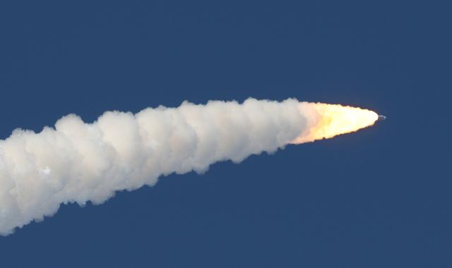 NASA's Artemis II Space Launch System (SLS) rocket and Orion spacecraft soars into orbit after lifting off from Launch Pad 39B at the Kennedy Space Center in Cape Canaveral, Florida on April 1, 2026. Four astronauts blasted off aboard a massive NASA rocket April 1 on a long-anticipated journey around the Moon, the first crewed lunar flyby in more than 50 years. With an intense roar that reverberated far beyond the launchpad, the enormous orange-and-white rocket carried three Americans and one Canadian away from Florida's Kennedy Space Center at approximately 6:35 pm local time, according to an AFP journalist onsite. "We're going to the Moon!" yelled a spectator. (Photo by Gregg Newton / AFP)