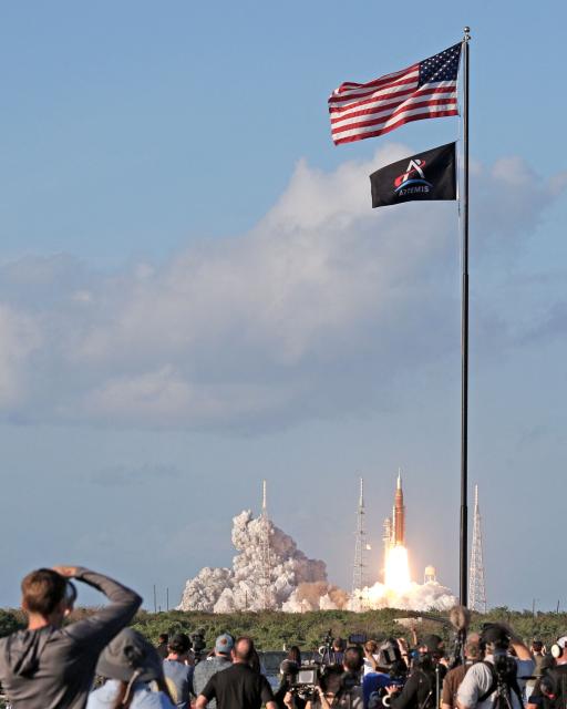 NASA's Artemis II Space Launch System (SLS) rocket and Orion spacecraft lifts off from Launch Pad 39B at the Kennedy Space Center in Cape Canaveral, Florida on April 1, 2026. Four astronauts blasted off aboard a massive NASA rocket April 1 on a long-anticipated journey around the Moon, the first crewed lunar flyby in more than 50 years. With an intense roar that reverberated far beyond the launchpad, the enormous orange-and-white rocket carried three Americans and one Canadian away from Florida's Kennedy Space Center at approximately 6:35 pm local time, according to an AFP journalist onsite. "We're going to the Moon!" yelled a spectator. (Photo by Gregg Newton / AFP)