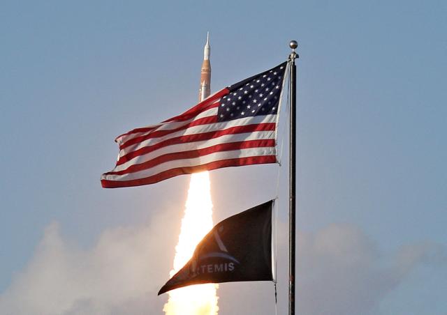NASA's Artemis II Space Launch System (SLS) rocket and Orion spacecraft lifts off from Launch Pad 39B at the Kennedy Space Center in Cape Canaveral, Florida on April 1, 2026. Four astronauts blasted off aboard a massive NASA rocket April 1 on a long-anticipated journey around the Moon, the first crewed lunar flyby in more than 50 years. With an intense roar that reverberated far beyond the launchpad, the enormous orange-and-white rocket carried three Americans and one Canadian away from Florida's Kennedy Space Center at approximately 6:35 pm local time, according to an AFP journalist onsite. "We're going to the Moon!" yelled a spectator. (Photo by Gregg Newton / AFP)