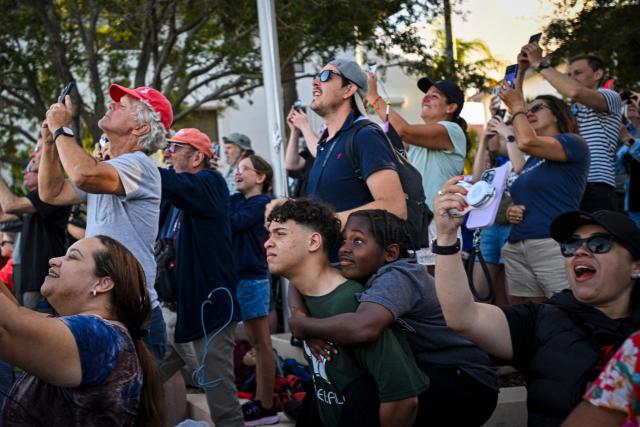 Space enthusiasts at a park in Titusville, view the Artemis II crewed lunar mission lift off from Pad 39B at Kennedy Space Center in Cape Canaveral, Florida, on April 1, 2026. Four astronauts blasted off aboard a massive NASA rocket April 1 on a long-anticipated journey around the Moon, the first crewed lunar flyby in more than 50 years. With an intense roar that reverberated far beyond the launchpad, the enormous orange-and-white rocket carried three Americans and one Canadian away from Florida's Kennedy Space Center at approximately 6:35 pm local time, according to an AFP journalist onsite. "We're going to the Moon!" yelled a spectator. (Photo by Miguel J Rodriguez Carrillo / AFP)