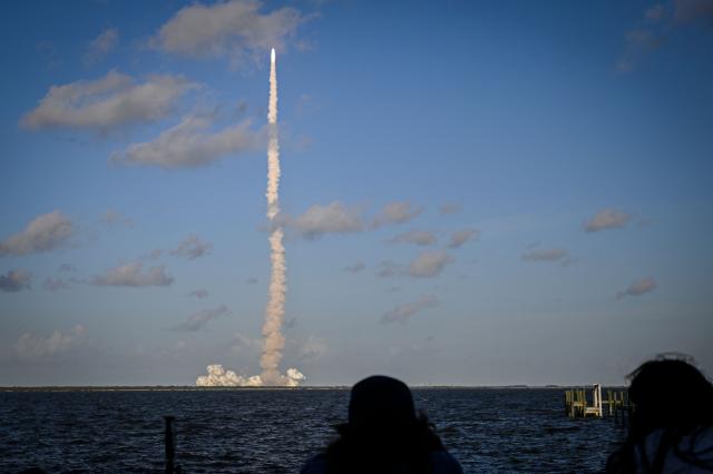 Space enthusiasts at a park in Titusville view the Artemis II crewed lunar mission lift off from Pad 39B at Kennedy Space Center in Cape Canaveral, Florida, on April 1, 2026. Four astronauts blasted off aboard a massive NASA rocket April 1 on a long-anticipated journey around the Moon, the first crewed lunar flyby in more than 50 years. With an intense roar that reverberated far beyond the launchpad, the enormous orange-and-white rocket carried three Americans and one Canadian away from Florida's Kennedy Space Center at approximately 6:35 pm local time, according to an AFP journalist onsite. "We're going to the Moon!" yelled a spectator. (Photo by Miguel J Rodriguez Carrillo / AFP)