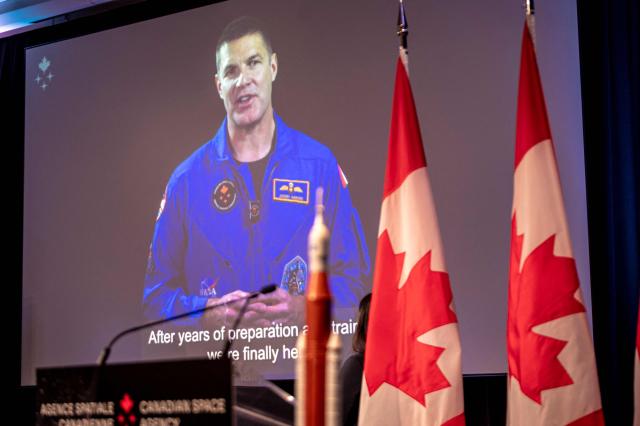 A pre-recorded video showing Canadian Space Agency (CSA) astronaut Jeremy Hansen is shown during a viewing party of the Artemis II launch, in Longueuil, near Montreal, Quebec, on April 1, 2026. Four astronauts blasted off aboard a massive NASA rocket April 1 on a long-anticipated journey around the Moon, the first crewed lunar flyby in more than 50 years. With an intense roar that reverberated far beyond the launchpad, the enormous orange-and-white rocket carried three Americans and one Canadian away from Florida's Kennedy Space Center at approximately 6:35 pm local time, according to an AFP journalist onsite. "We're going to the Moon!" yelled a spectator. (Photo by ANDREJ IVANOV / AFP)
