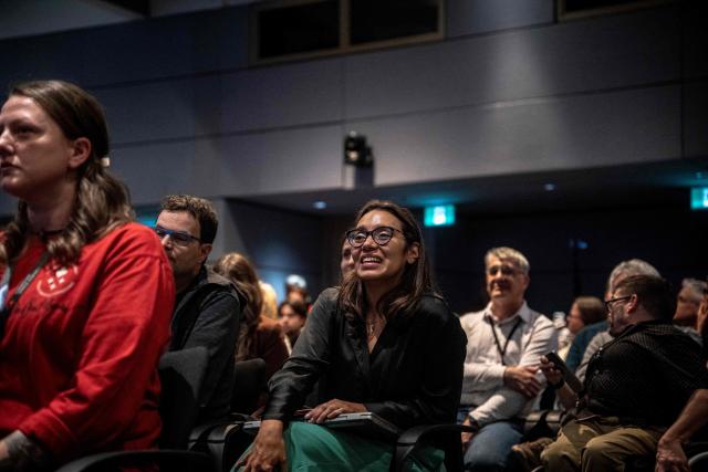 People react while watching the live broadcast of the Artemis II lunar mission launch, with Canadian Space Agency (CSA) astronaut Jeremy Hansen on board, during a viewing party at the CSA offices in Longueuil, near Montreal, Quebec, on April 1, 2026. Four astronauts blasted off aboard a massive NASA rocket April 1 on a long-anticipated journey around the Moon, the first crewed lunar flyby in more than 50 years. With an intense roar that reverberated far beyond the launchpad, the enormous orange-and-white rocket carried three Americans and one Canadian away from Florida's Kennedy Space Center at approximately 6:35 pm local time, according to an AFP journalist onsite. "We're going to the Moon!" yelled a spectator. (Photo by ANDREJ IVANOV / AFP)