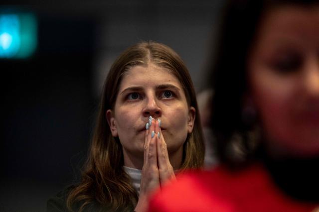 People react while watching the live broadcast of the Artemis II lunar mission launch, with Canadian Space Agency (CSA) astronaut Jeremy Hansen on board, during a viewing party at the CSA offices in Longueuil, near Montreal, Quebec, on April 1, 2026. Four astronauts blasted off aboard a massive NASA rocket April 1 on a long-anticipated journey around the Moon, the first crewed lunar flyby in more than 50 years. With an intense roar that reverberated far beyond the launchpad, the enormous orange-and-white rocket carried three Americans and one Canadian away from Florida's Kennedy Space Center at approximately 6:35 pm local time, according to an AFP journalist onsite. "We're going to the Moon!" yelled a spectator. (Photo by ANDREJ IVANOV / AFP)