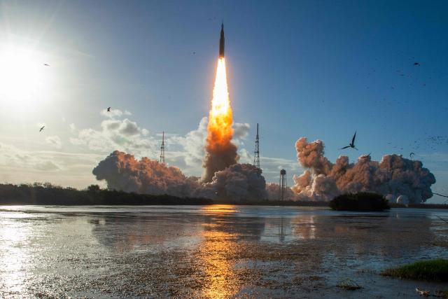 The Artemis II crewed lunar mission lifts off from Pad 39B at Kennedy Space Center in Cape Canaveral, Florida, on April 1, 2026. Four astronauts blasted off aboard a massive NASA rocket April 1 on a long-anticipated journey around the Moon, the first crewed lunar flyby in more than 50 years. With an intense roar that reverberated far beyond the launchpad, the enormous orange-and-white rocket carried three Americans and one Canadian away from Florida's Kennedy Space Center at approximately 6:35 pm local time, according to an AFP journalist onsite. "We're going to the Moon!" yelled a spectator. (Photo by Jim Watson / AFP)