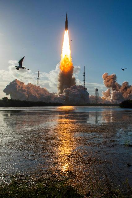 TOPSHOT - The Artemis II crewed lunar mission lifts off from Pad 39B at Kennedy Space Center in Cape Canaveral, Florida, on April 1, 2026. Four astronauts blasted off aboard a massive NASA rocket April 1 on a long-anticipated journey around the Moon, the first crewed lunar flyby in more than 50 years. With an intense roar that reverberated far beyond the launchpad, the enormous orange-and-white rocket carried three Americans and one Canadian away from Florida's Kennedy Space Center at approximately 6:35 pm local time, according to an AFP journalist onsite. "We're going to the Moon!" yelled a spectator. (Photo by Jim Watson / AFP)