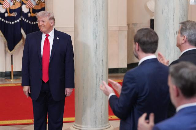 US Vice President JD Vance (2R), US Secretary of Treasury Scott Bessent (R) applaud as US President Donald Trump smiles after speaking during a televised address on the conflict in the Middle East from the Cross Hall of the White House in Washington, DC on April 1, 2026. (Photo by Alex Brandon / POOL / AFP)