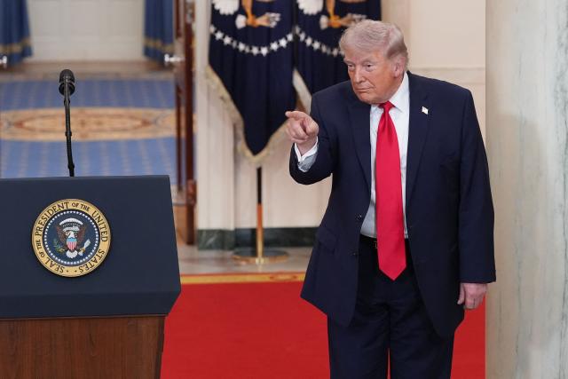 US President Donald Trump points after speaking at a televised address on the conflict in the Middle East from the Cross Hall of the White House in Washington, DC on April 1, 2026. (Photo by Alex Brandon / POOL / AFP)