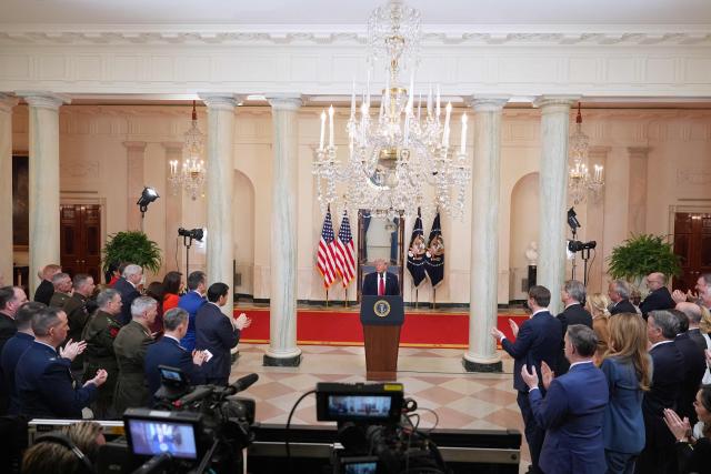 Guests applaud as US President Donald Trump concludes his televised address on the conflict in the Middle East from the Cross Hall of the White House in Washington, DC on April 1, 2026. (Photo by Alex Brandon / POOL / AFP)