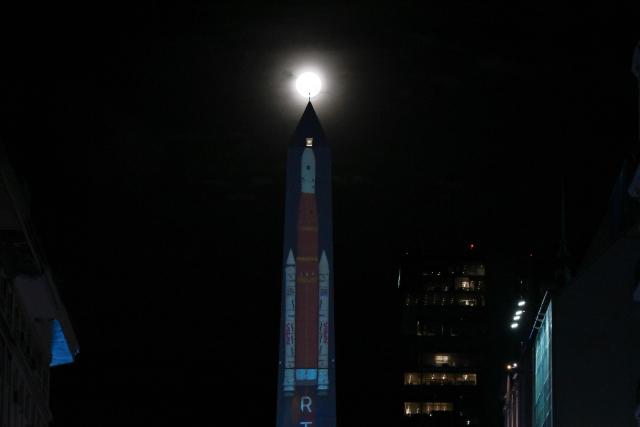 TOPSHOT - A projection depicting the lift-off of the Artemis II crewed lunar mission is displayed on the Obelisk in Buenos Aires on April 1, 2026. Four astronauts blasted off aboard a massive NASA rocket April 1 on a long-anticipated journey around the Moon, the first crewed lunar flyby in more than 50 years. With an intense roar that reverberated far beyond the launchpad, the enormous orange-and-white rocket carried three Americans and one Canadian away from Florida's Kennedy Space Center at approximately 6:35 pm local time, according to an AFP journalist onsite. "We're going to the Moon!" yelled a spectator. (Photo by Luis ROBAYO / AFP)