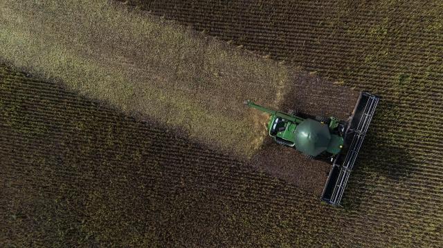 This aerial view shows a harvest machine working in a soybean field in Cruz Alta, Rio Grande do Sul state, Brazil, on April 1, 2026. (Photo by Silvio AVILA / AFP)
