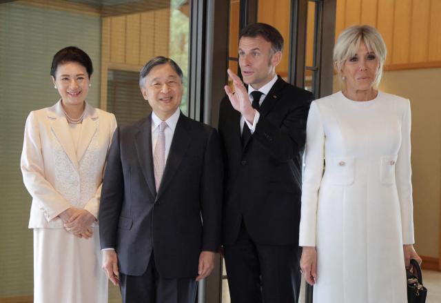 France's President Emmanuel Macron (2nd-R) waves as First Lady Brigitte Macron (R) looks on with Japan's Emperor Naruhito (2nd-L) and Empress Masako (L) at the  Imperial Palace in Tokyo on April 2, 2026. (Photo by Ludovic MARIN / POOL / AFP)