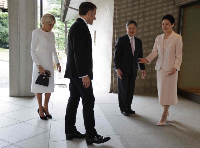 France's President Emmanuel Macron (L) and First Lady Brigitte Macron (2nd-L) are greeted by Japan's Emperor Naruhito (2nd-R) and Empress Masako at the Imperial Palace in Tokyo on April 2, 2026. (Photo by Ludovic MARIN / POOL / AFP)