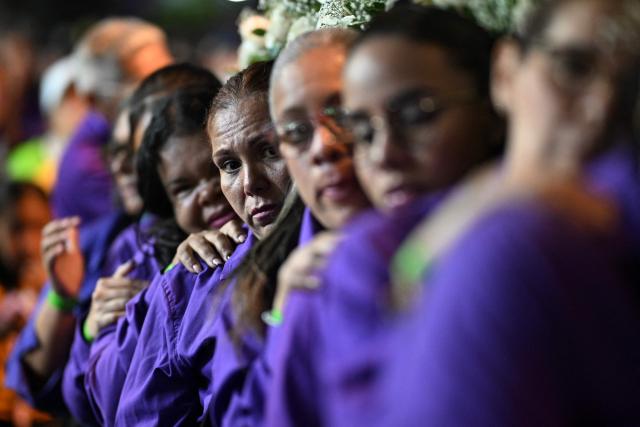Catholic faithful carry an image of Jesus Christ in a procession during Holy Week in Caracas on April 1, 2026. (Photo by Juan BARRETO / AFP)