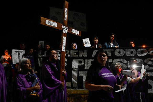 Catholic faithful and relatives of political prisoners take part in a procession outside El Rodeo prison during Holy Week in Guatire, Miranda state, Venezuela on April 1, 2026. (Photo by Maryorin Mendez / AFP)