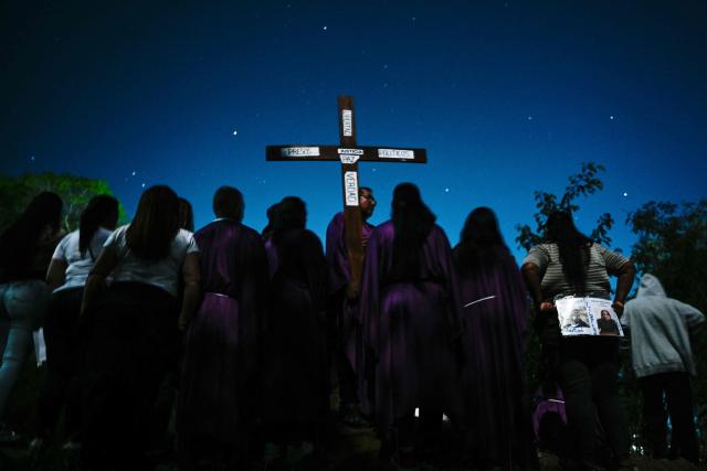 TOPSHOT - Catholic faithful and relatives of political prisoners take part in a procession outside El Rodeo prison during Holy Week in Guatire, Miranda state, Venezuela on April 1, 2026. (Photo by Maryorin Mendez / AFP)