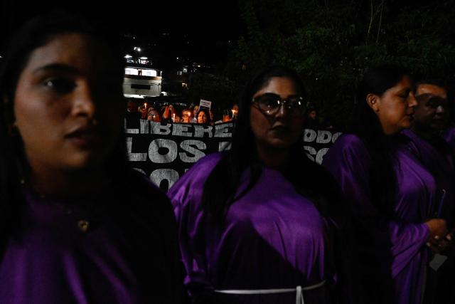 Catholic faithful and relatives of political prisoners take part in a procession outside El Rodeo prison during Holy Week in Guatire, Miranda state, Venezuela on April 1, 2026. (Photo by Maryorin Mendez / AFP)