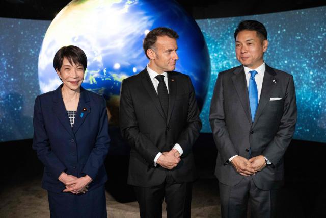 French President Emmanuel Macron (C) visits the company Astroscale, accompanied by Japanese Prime Minister Sanae Takaichi and Nobu Okada, founder and CEO at Astroscale, in Tokyo on April 2, 2026. (Photo by Jeanne ACCORSINI / POOL / AFP)