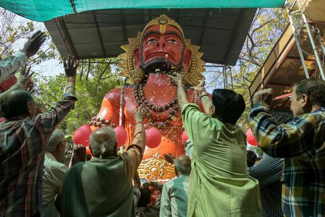 Devotees shower flower petals as they celebrate the birth anniversary of Hindu deity Hanuman at a temple in Amritsar on April 2, 2026. (Photo by Narinder NANU / AFP)