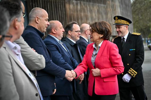 French Minister of Agriculture and Food Sovereignty Annie Genevard (2ndR) and FNSEA (French National Federation of Farmers' Unions) president Arnaud Rousseau (L) shake hands as she arrives to attend the 80th Congress of the FNSEA at the Exhibition Park in Caen on April 2, 2026. (Photo by LOU BENOIST / AFP)