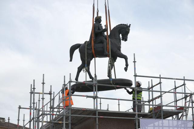 Workers lift a statue representing Napoleon I on a horse with a crane to place it back on its pedestal facing the sea as part of the renovation of the Charles de Gaulle Square in Ajaccio, on the French Mediterranean island of Corsica on April 2, 2026. (Photo by Pascal POCHARD-CASABIANCA / AFP)