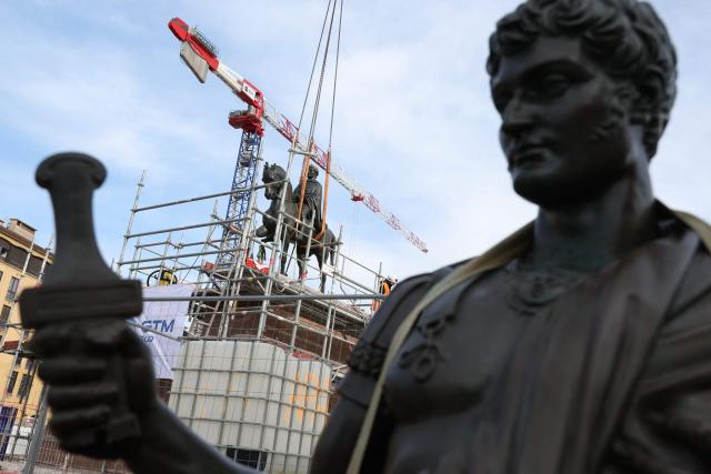 Workers operate around a statue representing Napoleon I on a horse after it was placed back on its pedestal facing the sea as part of the renovation of the Charles de Gaulle Square in Ajaccio, on the French Mediterranean island of Corsica on April 2, 2026. (Photo by Pascal POCHARD-CASABIANCA / AFP)