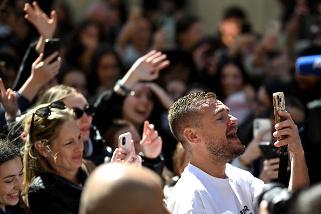 Content creator Jeremstar, whose real name is Jeremy Gisclon, poses for fans as he arrives for his trial at Nimes criminal court on charges of entering a competition area after interrupting a bullfight last September, in Nimes on April 2, 2026. (Photo by Gabriel BOUYS / AFP)