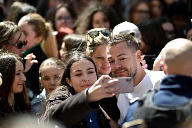 Content creator Jeremstar, whose real name is Jeremy Gisclon, poses for fans as he arrives for his trial at Nimes criminal court on charges of entering a competition area after interrupting a bullfight last September, in Nimes on April 2, 2026. (Photo by Gabriel BOUYS / AFP)