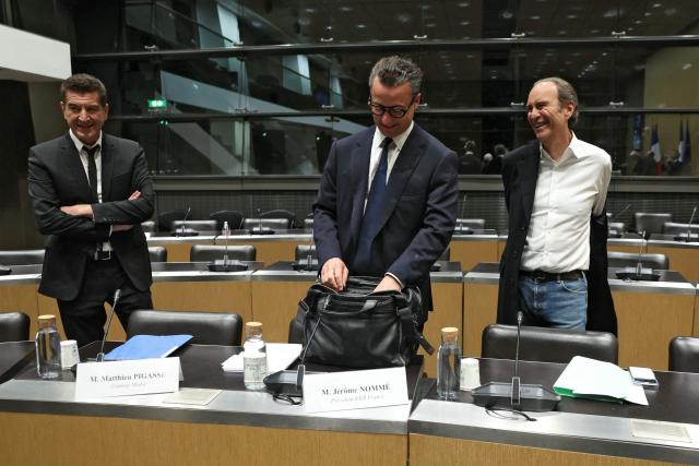 (LtoR) Combat press group founder Matthieu Pigasse, KKR France president Jerome Nomme  and Iliad and Free founder Xavier Niel, all shareholders of audiovisual production group Mediawan, arrive to attend a hearing before the Commission of Inquiry into the Neutrality, Operation and Funding of Public Broadcasting at the National Assembly in Paris on April 2, 2026. (Photo by ALAIN JOCARD / AFP)