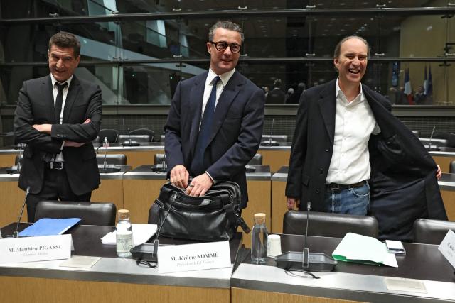 (LtoR) Combat press group founder Matthieu Pigasse, KKR France president Jerome Nomme  and Iliad and Free founder Xavier Niel, all shareholders of audiovisual production group Mediawan, arrive to attend a hearing before the Commission of Inquiry into the Neutrality, Operation and Funding of Public Broadcasting at the National Assembly in Paris on April 2, 2026. (Photo by ALAIN JOCARD / AFP)