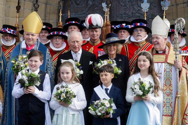 Members of the the Yeomen of the Guard, Britain's King Charles III, Britain's Queen Camilla and Bishop of St Asaph Gregory Cameron (R), pose for a formal photograph after the  Royal Maundy Service at St Asaph Cathedral, in north Wales on April 2, 2026. (Photo by Chris Jackson / POOL / AFP)