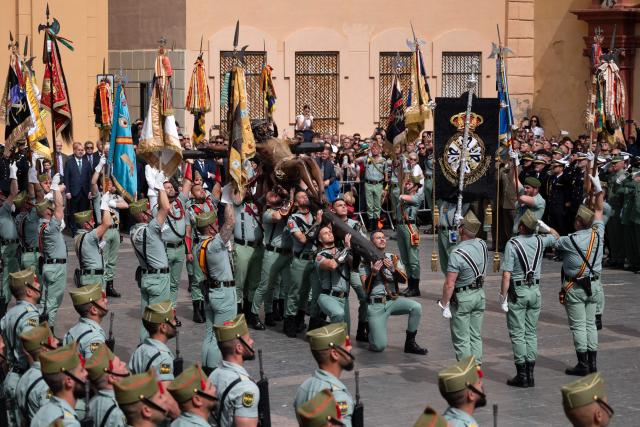 Members of the Spanish Legion carry a statue of the Christ of the Good Death to the Santo Domingo de Guzman church during a Holy Week procession in Malaga, southern Spain, on April 2, 2026. Spain's colourful Holy Week celebrations started this week, featuring centuries-old processions of the faithful carrying flower-covered floats topped with statues of Christ or the Virgin Mary that draw huge crowds. Organised by various religious brotherhoods, or "confradias", the parades are held across the country in the week leading up to Easter Sunday, which this year in the Roman Catholic Church falls on April 5, 2026. (Photo by JORGE GUERRERO / AFP)