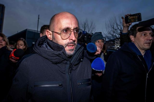 (FILES) The co-owner of Le Constellation bar Jacques Moretti (C) arrives with his lawyer, Patrick Michod (R) for a hearing before the public prosecutor of the canton of Valais, on February 6, 2026 in Sion, after 41 people, most of them teenagers, were killed, while 116 were injured, in a fire that ripped through in Le Constellation bar in the Alpine ski resort of Crans-Montana on New Year's Eve. The April 7, 2026, hearing of Jacques Moretti, co-owner of the bar that was set on fire on New Year's Eve in the Swiss resort of Crans-Montana, has been postponed by the public prosecutor's office after his lawyers submitted medical certificates. (Photo by Maxime SCHMID / AFP)