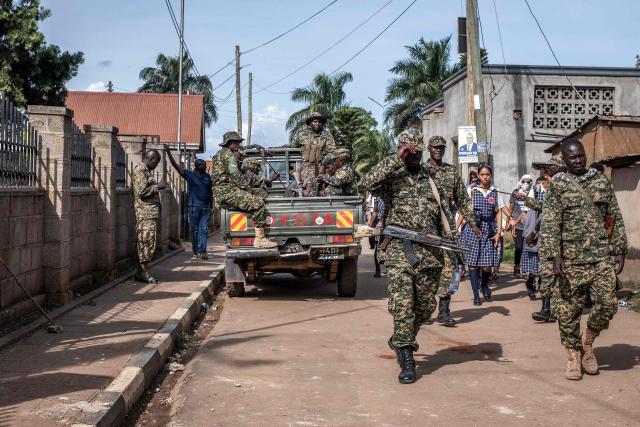 Ugandan military police patrol the fence around the Ggaba Early Childhood Development Program school following an attack on children in Kampala on April 2, 2026. Four children were stabbed to death on April 2, 2026 at a kindergarten in Uganda's capital, Kampala, police said.
The male suspect gained access by posing as a parent before attacking the children, who local media reported were aged between two and three. (Photo by Badru Katumba / AFP)