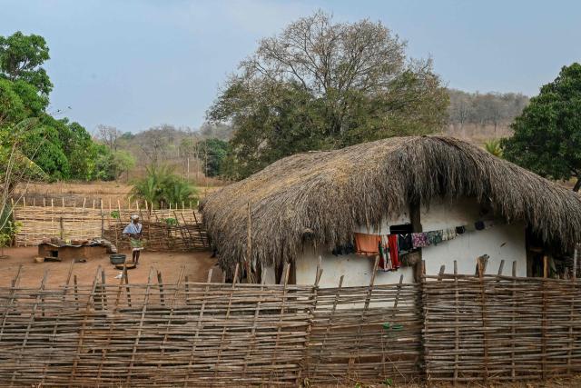 A woman stands outside her hut in Mohandi village in Chhattisgarh on April 2, 2026. (Photo by Shammi MEHRA / AFP)