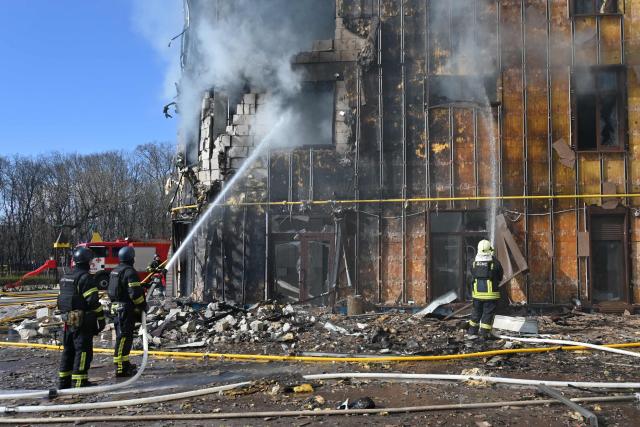 Ukrainian rescuers work to extinguish a fire in a damaged residential building following a drone attack in Kharkiv on April 2, 2026, amid the Russian invasion of Ukraine. (Photo by SERGEY BOBOK / AFP)