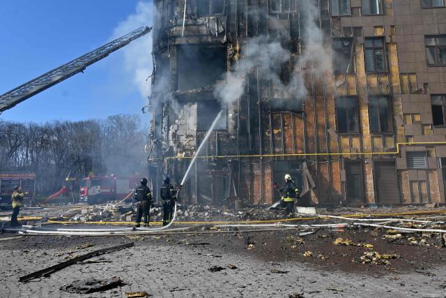 Ukrainian rescuers work to extinguish a fire in a damaged residential building following a drone attack in Kharkiv on April 2, 2026, amid the Russian invasion of Ukraine. (Photo by SERGEY BOBOK / AFP)