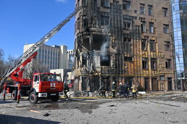 Ukrainian rescuers work to extinguish a fire in a damaged residential building following a drone attack in Kharkiv on April 2, 2026, amid the Russian invasion of Ukraine. (Photo by SERGEY BOBOK / AFP)