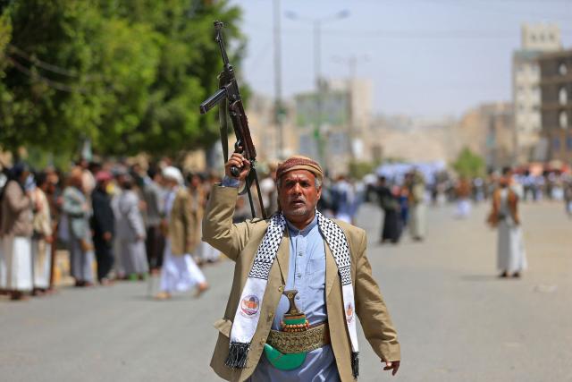 A Yemeni demonstrator carrying a weapon walks along a street in Sanaa on April 2, 2026, during a protest against the Israeli parliament's approval of a new death penalty bill for Palestinians convicted of deadly attacks. The bill would make the death penalty the default punishment for Palestinians in the Israeli-occupied West Bank found guilty of intentionally carrying out deadly attacks deemed "acts of terrorism" by an Israeli military court. (Photo by Mohammed HUWAIS / AFP)