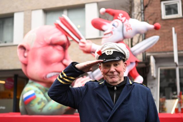 (FILES) German carnival float builder Jacques Tilly poses for photographers in front of one his creation, a carnival float featuring Russian President Vladimir Putin, during the parade to celebrate Rose Monday (Rosenmontag), on February 16, 2026 in Duesseldorf, western Germany. According to German media, a Russian court has sentenced German sculptor Jacques Tilly to more than eight years in prison in absentia in a controversial trial in Moscow. Tilly, widely known for his sharply satirical carnival floats, responded to the verdict with mockery rather than concern. (Photo by INA FASSBENDER / AFP)