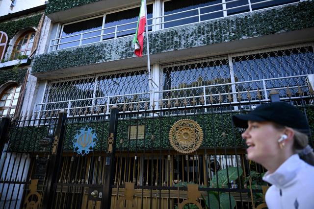 (FILES) A woman walks past the Iranian embassy in Buenos Aires on June 20, 2025. Argentina declared Iran's Counselor and Acting Charge d'Affaires, Mohsen Soltani Tehrani, *persona non grata* and ordered him to leave the country within 48 hours, the Foreign Ministry reported on April 2, 2026. (Photo by Luis ROBAYO / AFP)