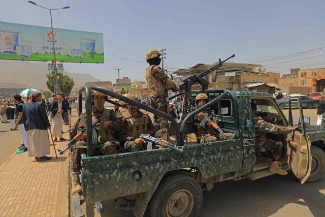 Yemeni security personnel keep vigil as supporters of Iran-backed Houthis, gather in Sanaa on April 2, 2026, during a protest against the Israeli parliament's approval of a new death penalty bill for Palestinians convicted of deadly attacks. The bill would make the death penalty the default punishment for Palestinians in the Israeli-occupied West Bank found guilty of intentionally carrying out deadly attacks deemed "acts of terrorism" by an Israeli military court. (Photo by Mohammed HUWAIS / AFP)