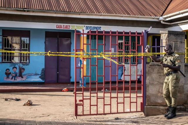 A Ugandan police officer monitors access at the entrance of the Ggaba Early Childhood Development Program school following an attack on children in Kampala on April 2, 2026. Four children were stabbed to death on April 2, 2026 at a kindergarten in Uganda's capital, Kampala, police said.
The male suspect gained access by posing as a parent before attacking the children, who local media reported were aged between two and three. (Photo by Badru Katumba / AFP)